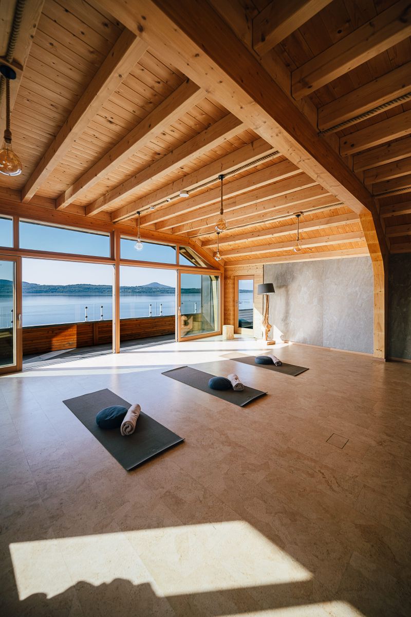 The hotel's yoga room with panoramic windows and a view over the lake