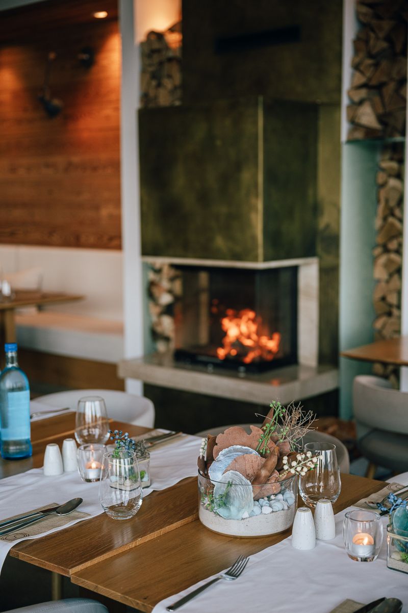 Blick auf den Kamin und einen eingedeckten Brunch-Tisch im Kaminzimmer